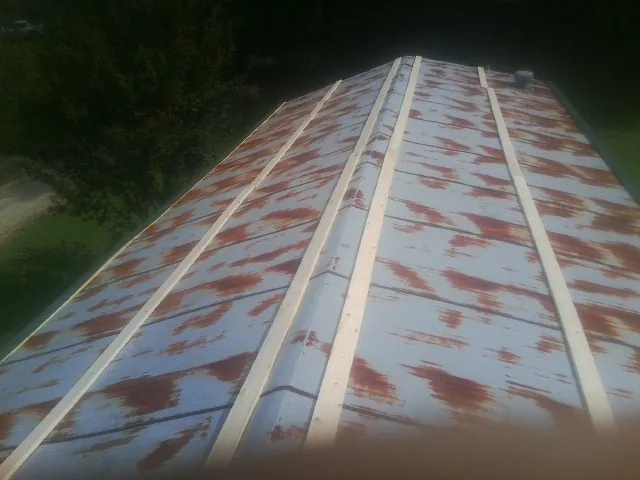 Rusted metal roof panels with new wood purlins before replacement — Storm Damage Roof Repair in Jacumba by Roofing Brothers