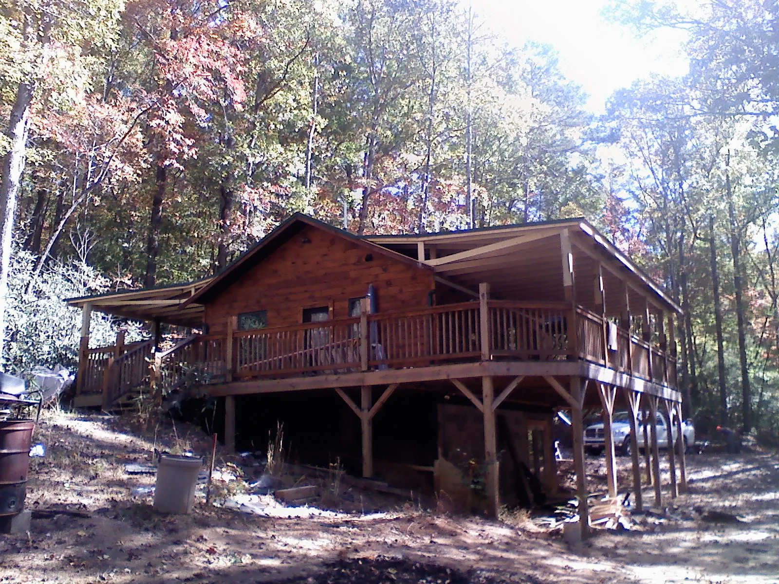Log cabin with a wraparound porch and metal roof in the fall in Jacumba